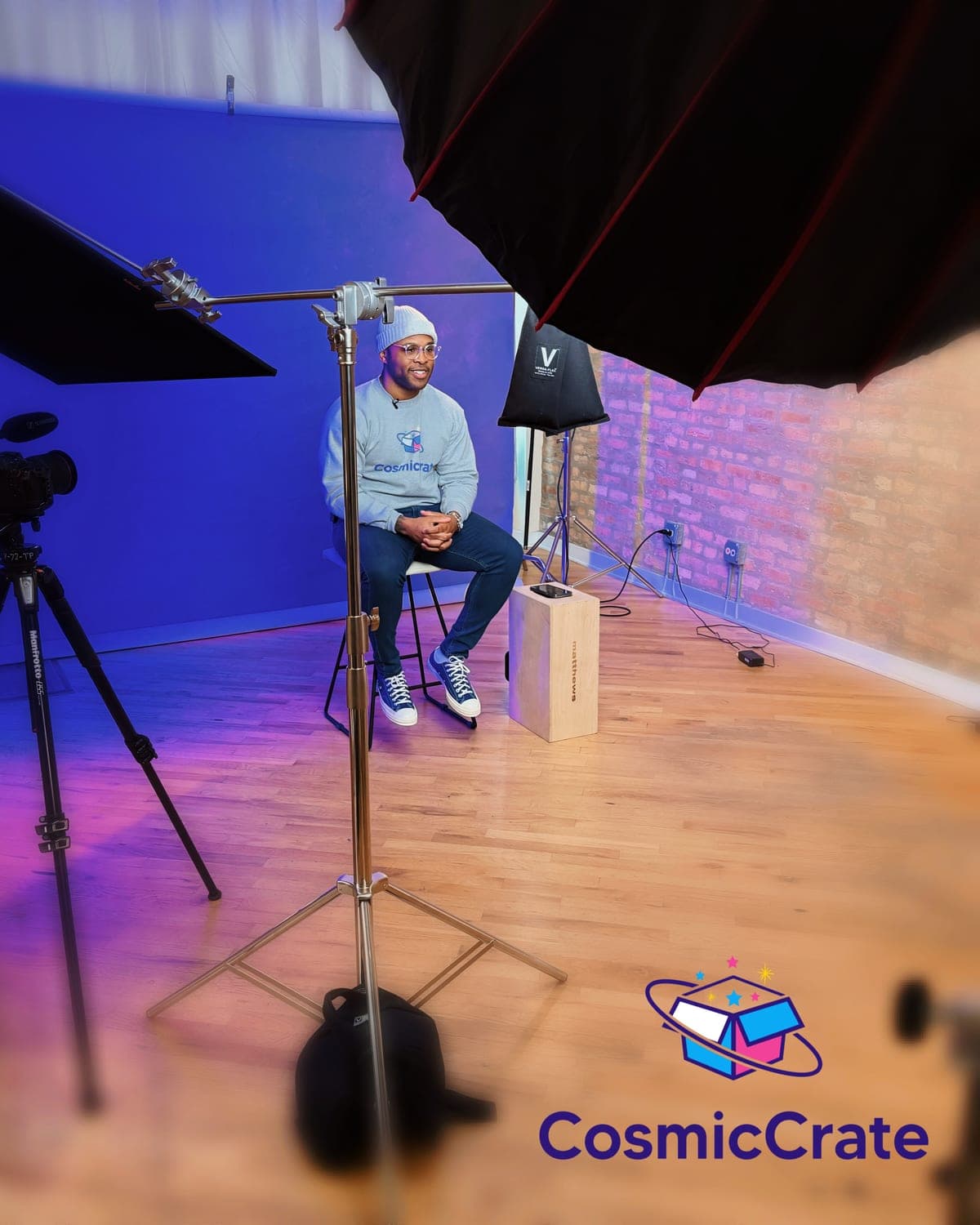Dion Dawson, CEO and Chief Dreamer of Cosmic Crate, seated in a studio in a Cosmic Crate sweatshirt.